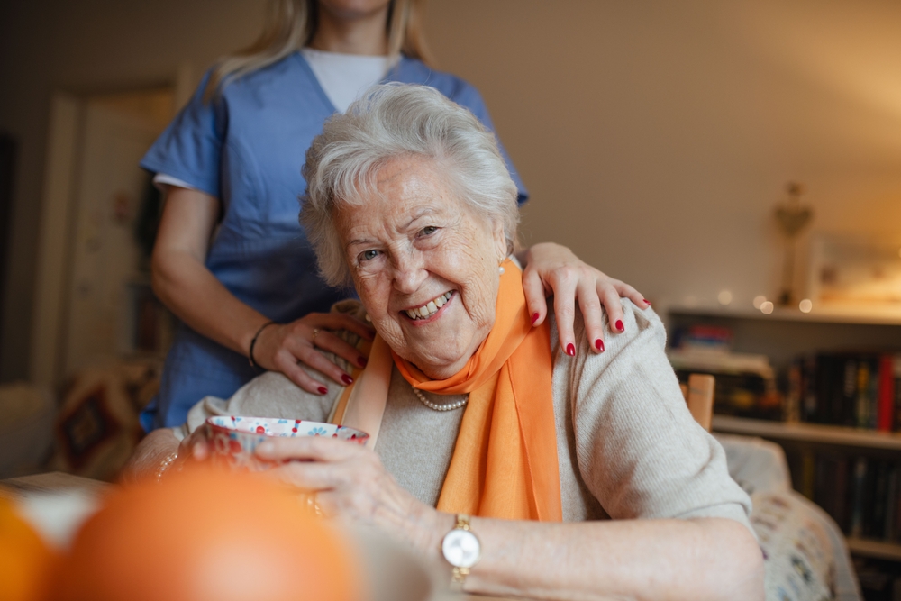 Professional carer providing home care support to an elderly client in Glenfield